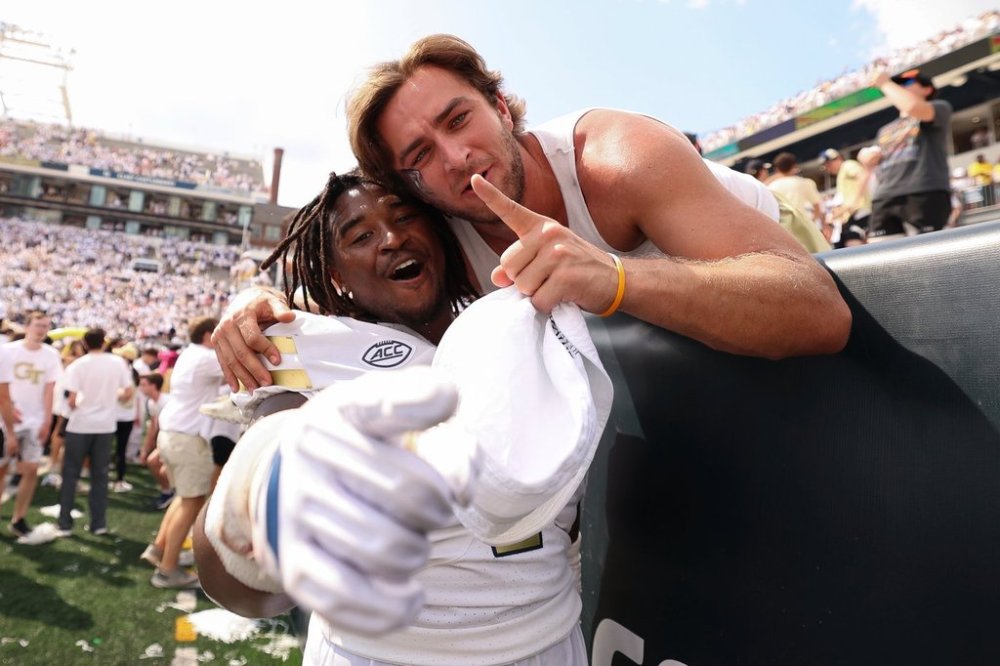 FILE - Georgia Tech defensive lineman Akelo Stone, left, celebrates with a fan after an NCAA college football game against Clemson, Saturday, Sept. 13, 2025, in Atlanta. (AP Photo/Colin Hubbard, file)