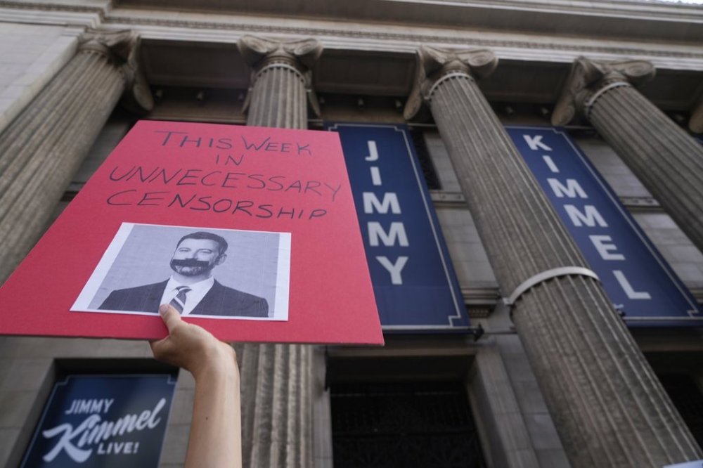 A demonstrator holds a sign outside El Capitan Entertainment Centre, where the late-night show