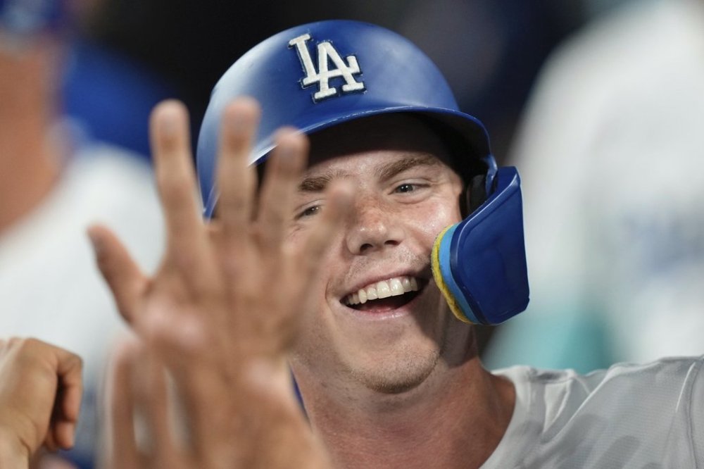 Los Angeles Dodgers' Will Smith is congratulated by teammates in the dugout after scoring on a wild pitch during the second inning of a baseball game against the Colorado Rockies, Tuesday, Sept. 9, 2025, in Los Angeles. (AP Photo/Mark J. Terrill)