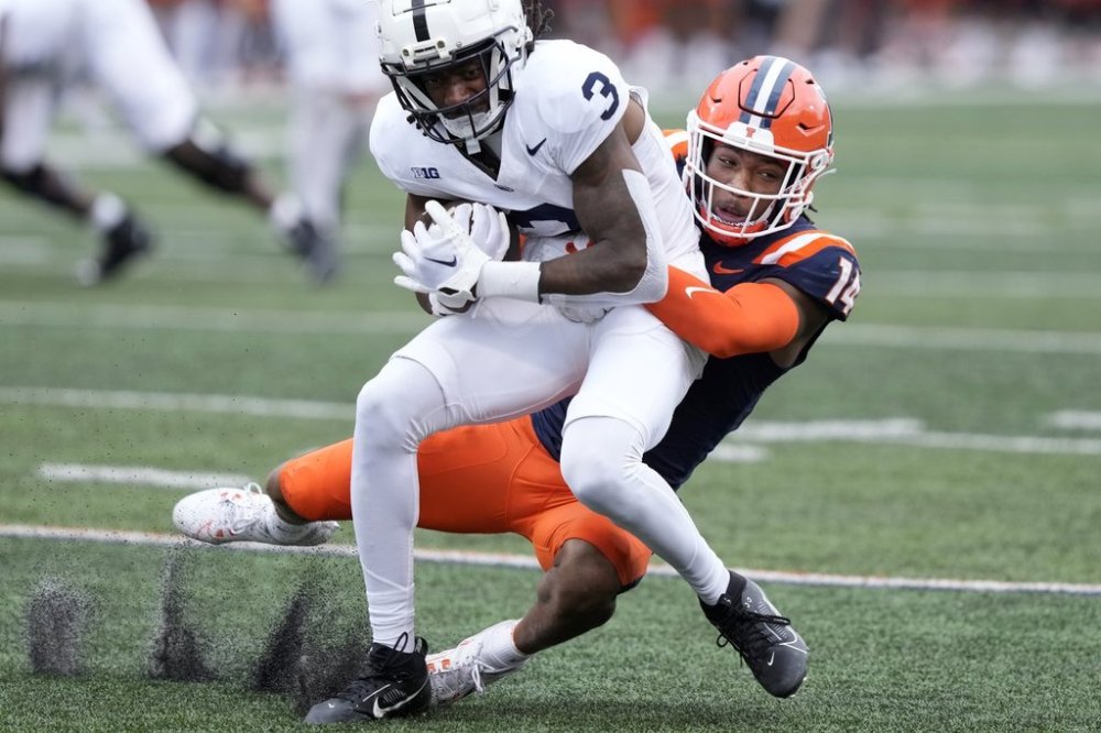 FILE - Penn State wide receiver Dante Cephas (3) carries the ball after a reception as Illinois defensive back Xavier Scott, right, tackles him during an NCAA college football game Sept. 16, 2023, in Champaign, Ill. (AP Photo/Charles Rex Arbogast, File)