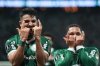 Jose Manuel Lopez of Brazil's Palmeiras, left, celebrates with Vitor Roque of Brazil's Palmeiras, after scoring a penalty goal against Argentina's River Plate during a Copa Libertadores quarterfinal second leg soccer match at Allianz Parque stadium in Sao Paulo, Wednesday, Sept. 24, 2025. (AP Photo/Andre Penner)