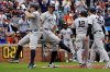 New York Yankees' Ben Rice, left, celebrates with Aaron Judge, second from left, after hitting a grand slam during the 10th inning of a baseball game against the Baltimore Orioles, Sunday, Sept. 21, 2025, in Baltimore. (AP Photo/Peter Casey)