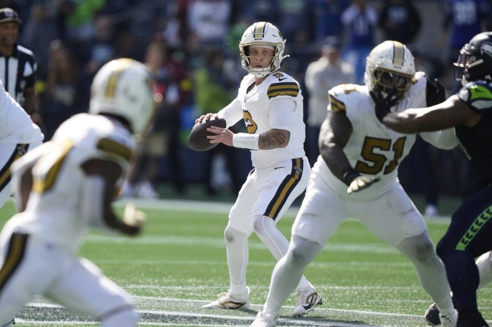 New Orleans Saints quarterback Spencer Rattler (2) drops back to pass during the first half of an NFL football game against the Seattle Seahawks, Sunday, Sept. 21, 2025, in Seattle. (AP Photo/Stephen Brashear)