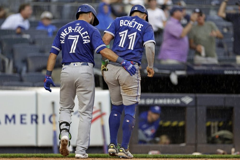Toronto Blue Jays' Bo Bichette (11) is helped off the field by Isiah Kiner-Falefa (7) after being tagged out at home during the sixth inning of a baseball game agains the New York Yankees, Saturday, Sept. 6, 2025, in New York. (AP Photo/Adam Hunger)