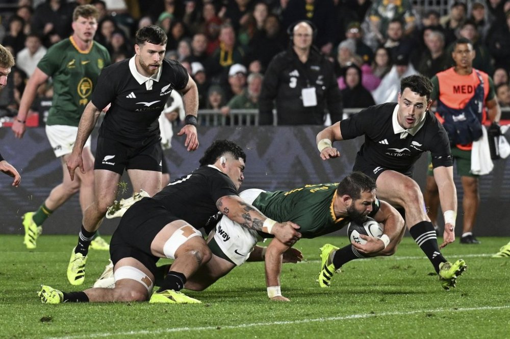 Cobus Reinach of South Africa scores a try during their rugby international against the All Blacks at Eden Park in Auckland, New Zealand, Saturday, Sept. 6, 2025. (Jeremy Ward/Photosport via AP)