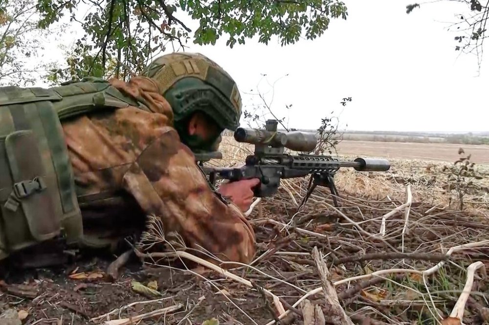 In this photo taken from video distributed by Russian Defense Ministry Press Service on Monday, Oct. 6, 2025, a Russian sniper fires towards Ukrainian forces from an undisclosed location. (Russian Defense Ministry Press Service via AP)