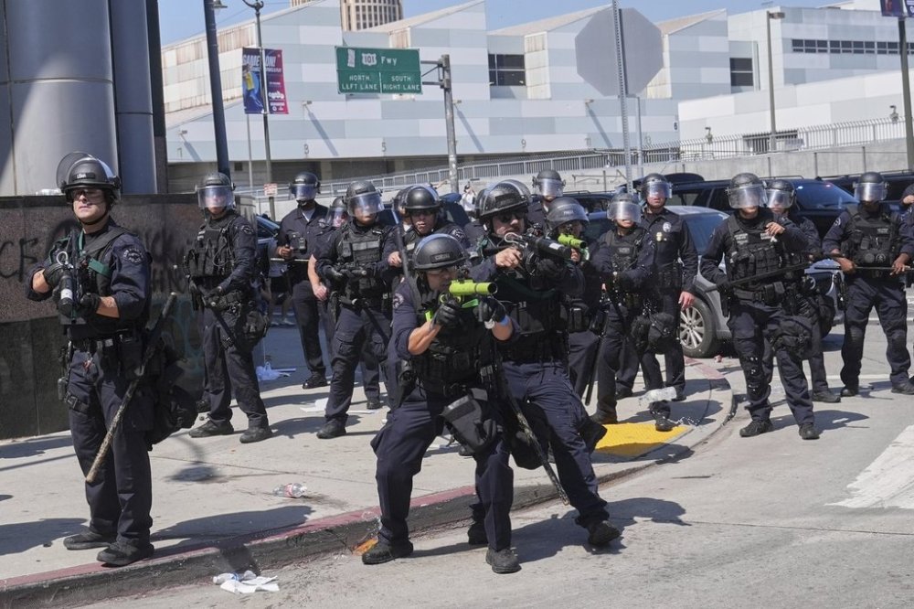 FILE - Police defend the Metropolitan Detention Center in downtown Los Angeles, June 8, 2025, following an immigration raid protest the previous day.(AP Photo/Jae Hong, File)