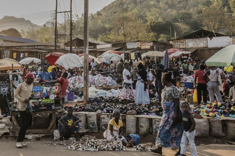 A woman and a child walk past a market in Zomba, Malawi, Wednesday, Sept. 10, 2025. (AP Photo/Thoko Chikondi)