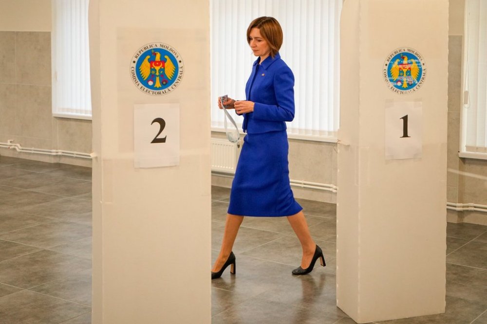 Moldova's President Maia Sandu enters a voting booth during a parliamentary election, in Chisinau, Moldova, Sunday, Sept. 28, 2025. (AP Photo/Vadim Ghirda)