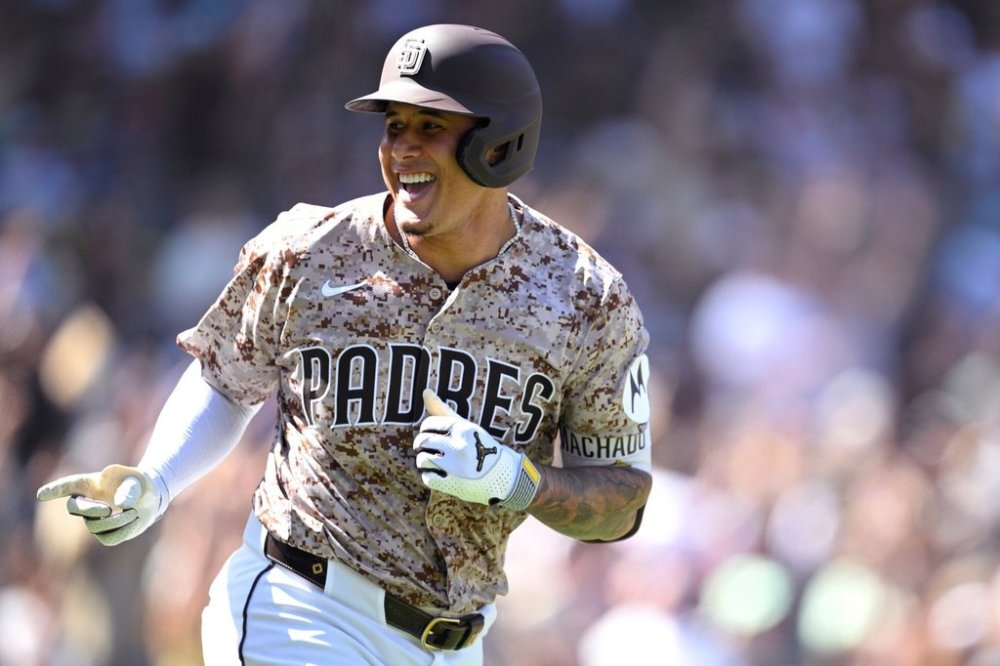 San Diego Padres' Manny Machado gestures toward his dugout after hitting a solo home run against the Arizona Diamondbacks during the third inning of a baseball game Sunday, Sept. 28, 2025, in San Diego. (AP Photo/Orlando Ramirez)