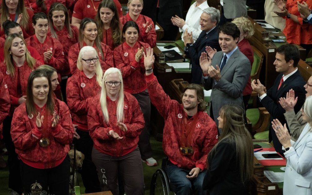 Wheelchair racer Austin Smeenk, of Oakville, Ont., waves to the gallery as parliamentarians recognize athletes who competed for Canada at the 2024 Paris Olympics and Paralympic Games at a ceremony in the House of Commons, in Ottawa, Wednesday, Dec. 4, 2024. THE CANADIAN PRESS/Adrian Wyld