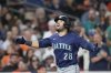 Seattle Mariners' Eugenio Suárez runs the bases after hitting a solo home run during the fourth inning of a baseball game against the Houston Astros, Friday, Sept. 19, 2025, in Houston. (AP Photo/Kevin M. Cox)