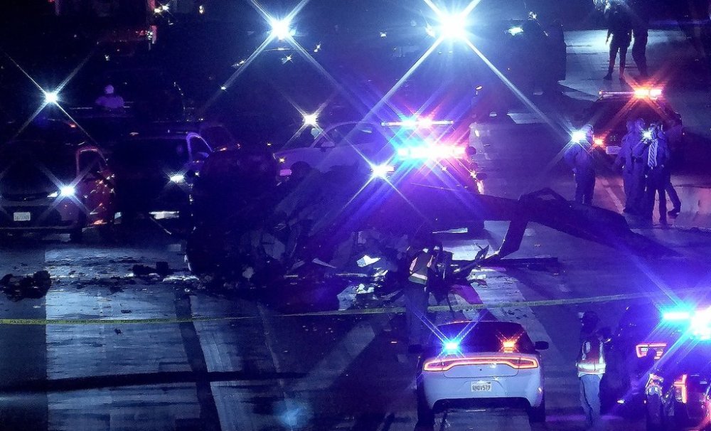 Emergency personnel surround the wreckage of a helicopter that crashed on eastbound Highway 50 in Sacramento, Calif., Monday, Oct. 6, 2025. (AP Photo/Rich Pedroncelli)