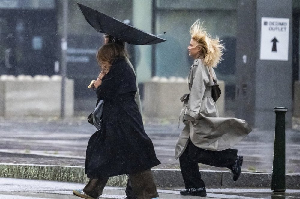 People struggle against the wind and rain in Malmö, Sweden, after a storm reached southern Sweden, Saturday Oct. 4, 2025. (Johan Nilsson/TT via AP)