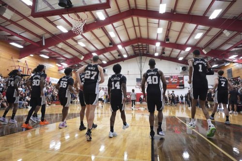 San Antonio Spurs players make a surprise visit to Tom Moore High School in Ingram, Texas, to visit the students and families of those impacted by flooding that killed more than 130 people across the region,Wednesday, Sept. 10, 2025. (AP Photo/Eric Gay)