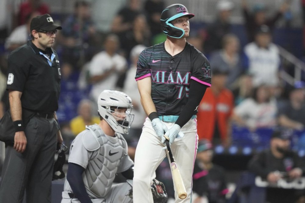 Miami Marlins' Troy Johnston, right, watches after hitting a walk-off two run home run during the 11th inning of a baseball game against the Detroit Tigers, Saturday, Sept. 13, 2025, in Miami. (AP Photo/Lynne Sladky)
