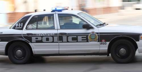 A Winnipeg Police Service cruiser car with lights and sirens responds to a call through downtown Winnipeg Wednesday morning-For files- Sept 11, 2013 (JOE BRYKSA / WINNIPEG FREE PRESS)