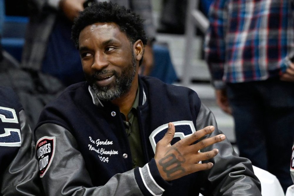 FILE- Former UConn and NBA player Ben Gordon sits on the sideline during a ceremony honoring the 2004 UConn men's championship basketball team during halftime of an NCAA college basketball game against Xavier, Jan. 28, 2024, in Hartford, Conn. (AP Photo/Jessica Hill, File)