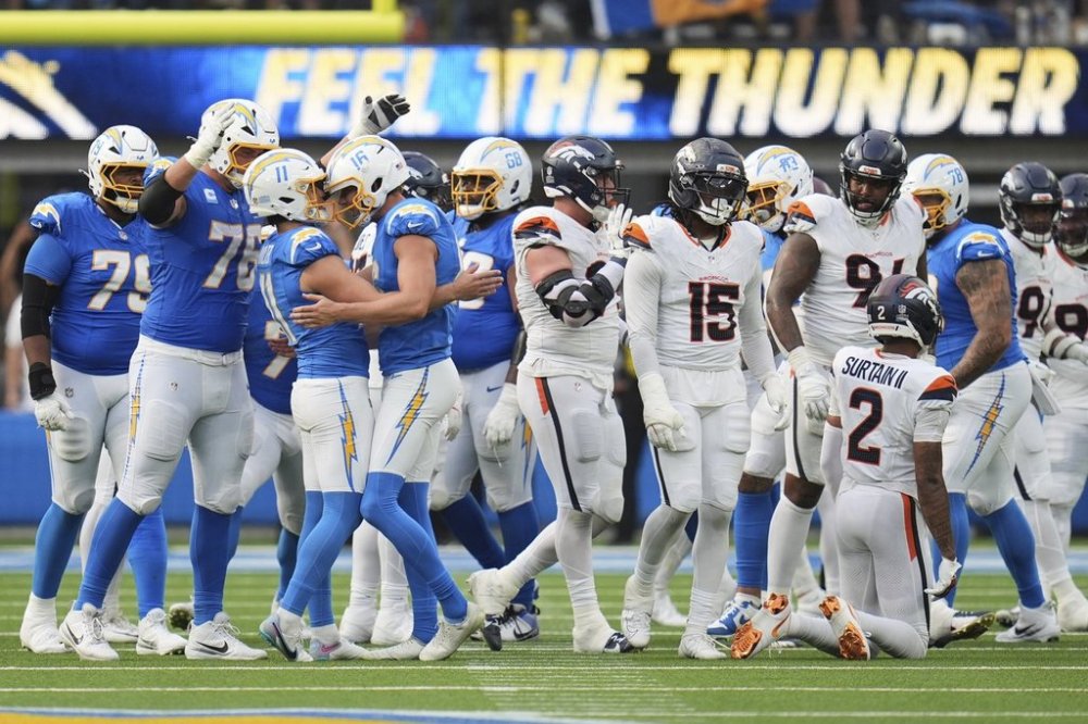 Los Angeles Chargers kicker Cameron Dicker (11) celebrates his game-winning field goal with teammates in an NFL football game against the Denver Broncos, Sunday, Sept. 21, 2025, in Inglewood, Calif. (AP Photo/Gregory Bull)