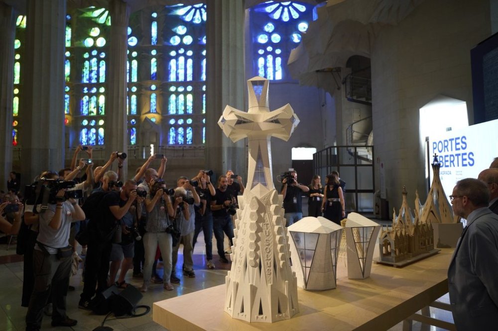 Miniature replicas of the new central tower that will crown the Basilica of the Sagrada Familia, making it the largest Christian church in Europe, are displayed during a press conference in Barcelona, Spain, Thursday, Sept. 18, 2025. (AP Photo/Emilio Morenatti)