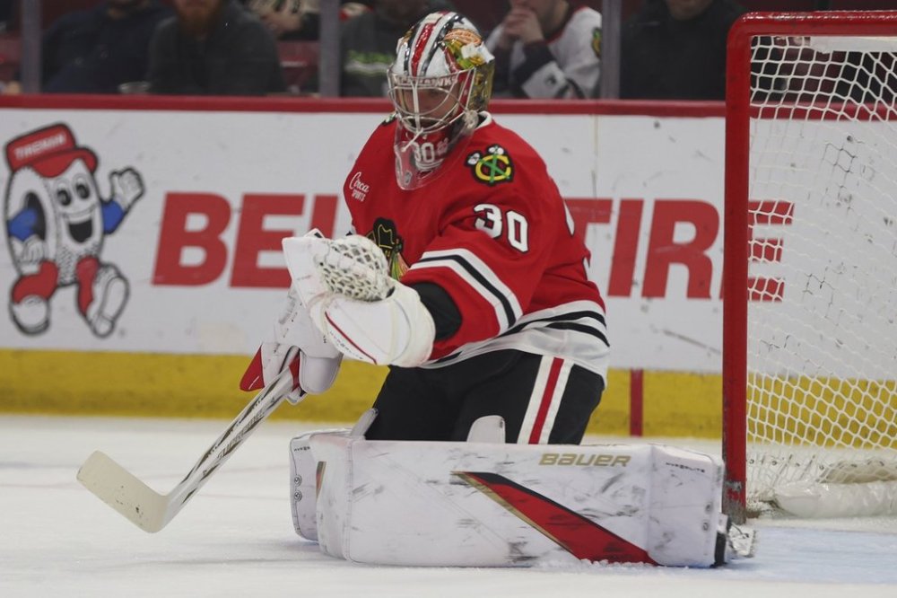 FILE - Chicago Blackhawks goaltender Spencer Knight (30) makes a save during the first period of an NHL hockey game against the Vegas Golden Knights Friday, March 28, 2025, in Chicago. (AP Photo/Melissa Tamez, File)