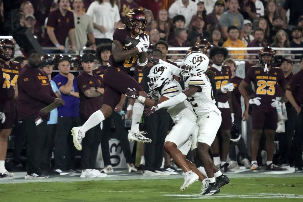 Arizona State wide receiver Jordyn Tyson (0) makes the catch over Texas State safety Ryan Nolan and safety Will Mitchell II (22) in the first half of an NCAA college football game, Saturday, Sept. 13, 2025, in Tempe, Ariz. (AP Photo/Rick Scuteri)