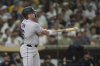 Colorado Rockies' Blaine Crim watches his three-run home run during the fourth inning of a baseball game against the San Diego Padres Friday, Sept. 12, 2025, in San Diego. (AP Photo/Gregory Bull)