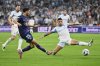 PSG's Warren Zaire-Emery kicks the ball ahead of Marseille's Emerson Palmieri during the French League One soccer match between Marseille and Paris Saint-Germain at Orange Velodrome in Marseille, France, Monday, Sept. 22, 2025. (AP Photo/Philippe Magoni)