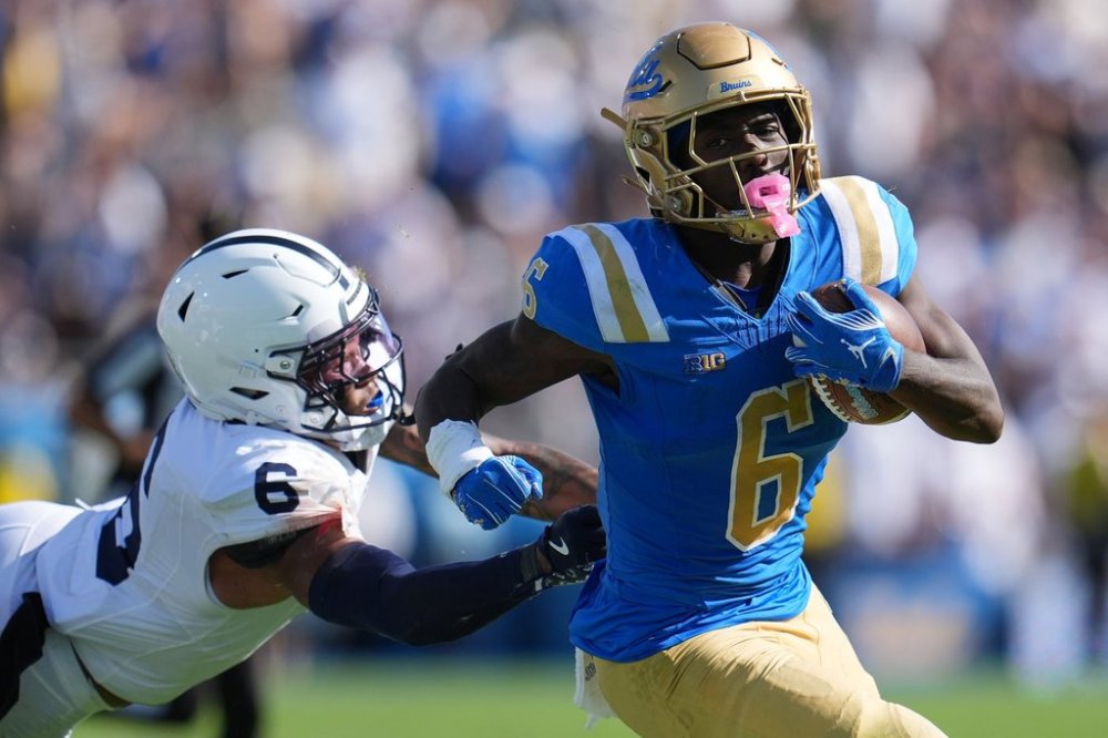 UCLA running back Anthony Woods (6) runs past Penn State safety Zakee Wheatley (6) during the second half of an NCAA college football game Saturday, Oct. 4, 2025, in Pasadena, Calif. (AP Photo/Marcio Jose Sanchez)