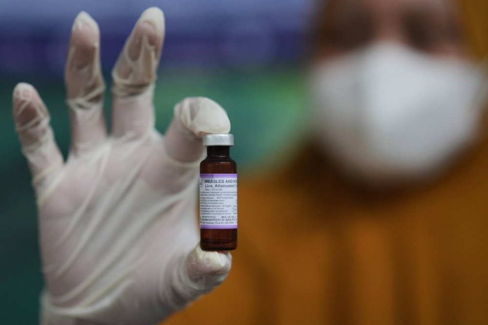 A health worker shows a vial of measles-rubella vaccine during a vaccination campaign in Sumenep on Madura Island, Indonesia, Monday, Sept. 8, 2025. (AP Photo/Dita Alangkara)