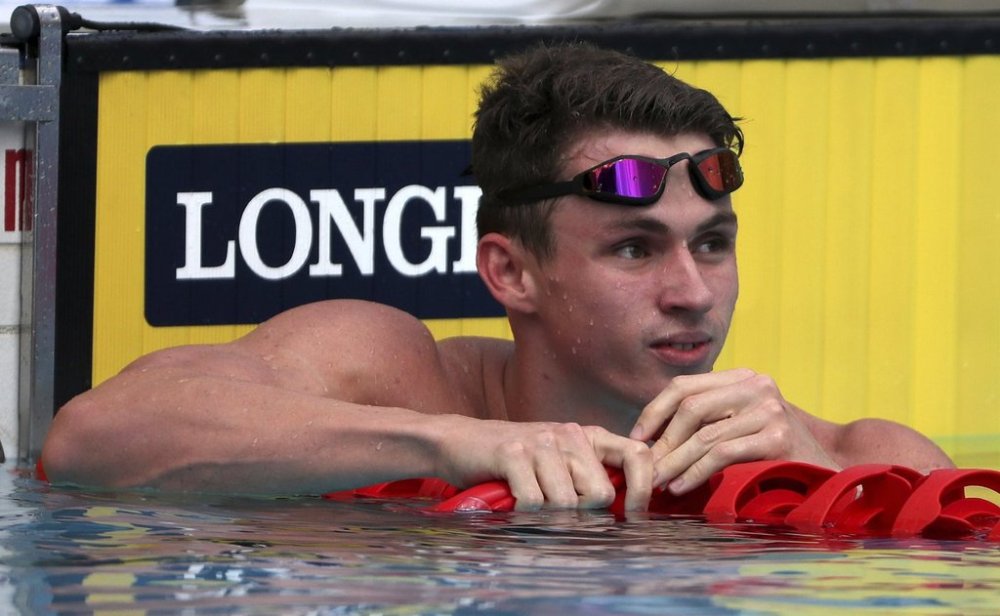FILE- England's Ben Proud reacts after he was disqualified in his men's 50m butterfly heat during the 2018 Commonwealth Games at the Aquatic Centre on the Gold Coast, Australia, Thursday, April 5, 2018. (AP Photo/Rick Rycroft)