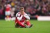 Arsenal's Martin Odegaard reacts of being injured during the English Premier League soccer match between Arsenal and West Ham United at the Emirates stadium in London, Saturday, Oct. 4, 2025. (AP Photo/Kirsty Wigglesworth)