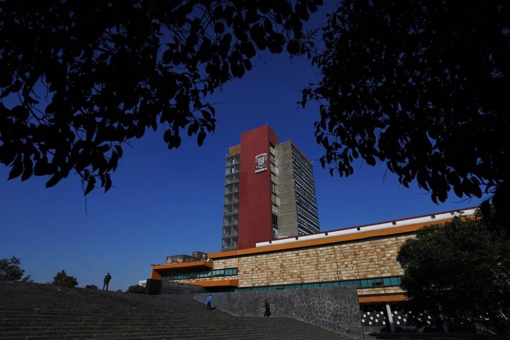 FILE - People walk by the Dean's Office Building of the National Autonomous University of Mexico (UNAM) in Mexico City, Jan. 23, 2023. (AP Photo/Marco Ugarte, File)