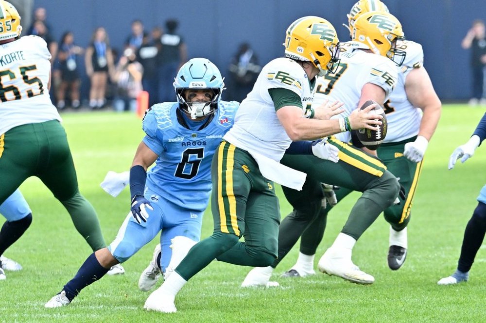 Toronto Argonauts' defensive back Branden Dozier (6) sacks Edmonton Elks quarterback Cody Fajardo, with ball, during first half CFL football action in Toronto, Saturday, Sept. 13, 2025. THE CANADIAN PRESS/Jon Blacker