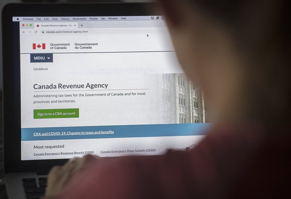 A person looks at a Canada Revenue Agency homepage in Montreal, Sunday, August 16, 2020. THE CANADIAN PRESS/Graham Hughes