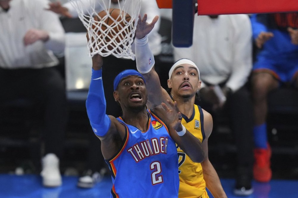 Oklahoma City Thunder guard Shai Gilgeous-Alexander, left, shoots against Indiana Pacers guard Andrew Nembhard during the second half of Game 7 of the NBA Finals basketball series Sunday, June 22, 2025, in Oklahoma City. (AP Photo/Nate Billings)
