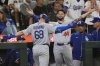 Los Angeles Dodgers' Dalton Rushing (68) celebrates with Andy Pages (44) after hitting a two-run go-ahead home run that scored Miguel Rojas during the fifth inning of a baseball game against the Seattle Mariners, Saturday, Sept. 27, 2025, in Seattle. (AP Photo/Ryan Sun)