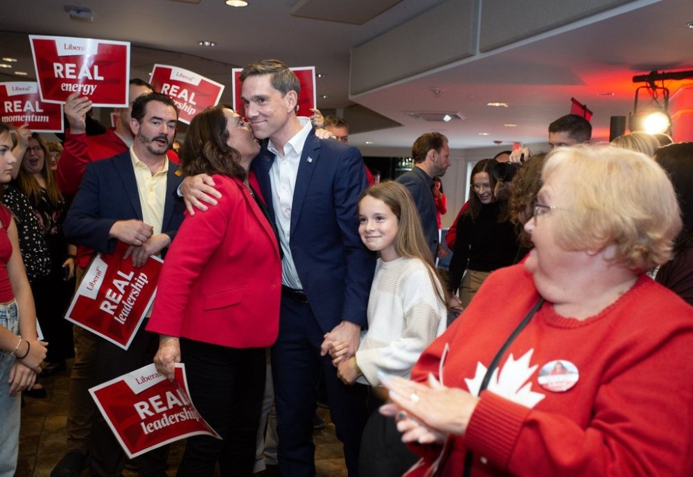 Former deputy premier Siobhan Coady greets Liberal leader John Hogan, with his daughter Maggie, at a rally in St. John's, Monday, Sept. 15, 2025, to start the 2025 provincial election campaign. THE CANADIAN PRESS/Paul Daly
