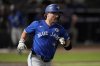 Toronto Blue Jays utilityman Davis Schneider runs to first base after his single off Rays pitcher Joe Boyle during the second inning of a Major League Baseball game on Sept. 15, 2025, in Tampa, Fla. (AP Photo/Chris O'Meara)