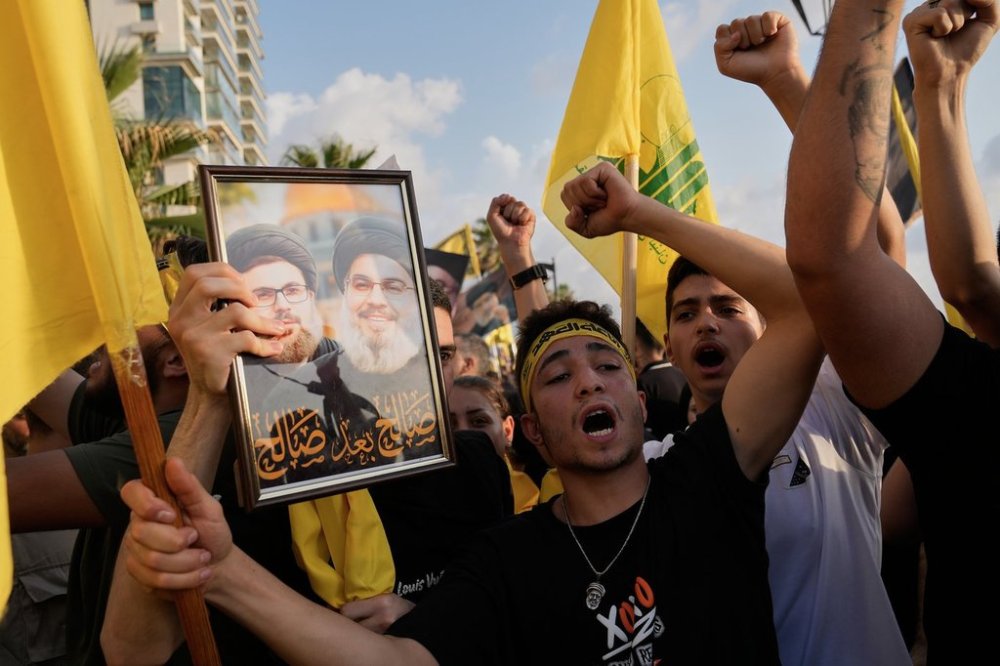 Hezbollah supporters shout slogans during an event commemorating the anniversary assassination of late Hezbollah leader Sayyed Hassan Nasrallah, in Beirut, Lebanon, Thursday, Sept. 25, 2025. (AP Photo/Hussein Malla)