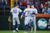 From left, Los Angeles Dodgers shortstop Mookie Betts, left fielder Kiké Hernández, and second baseman Tommy Edman celebrate after the team's win in Game 2 of baseball's National League Division Series against the Philadelphia Phillies, Monday, Oct. 6, 2025, in Philadelphia. (AP Photo/Matt Slocum)