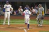 Texas Rangers' Michael Helman (24) prepares to cross home after hitting a two-run home run to score Jonah Heim, left, as Milwaukee Brewers catcher William Contreras, right, looks on during the fifth inning of a baseball game Tuesday, Sept. 9, 2025, in Arlington, Texas. (AP Photo/Julio Cortez)