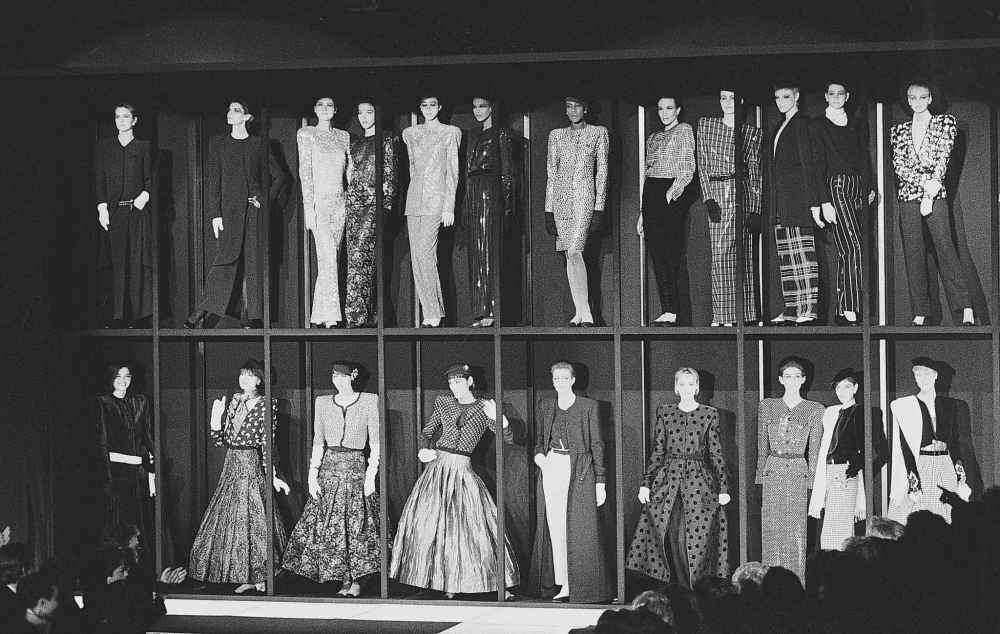 FILE - Models presenting the Giorgio Armani fashion collection stand in showcases at the end of the showing for Fall-Winter 1985-86 in Milan, March 13, 1985. (AP Photo/Ferdinando Meazza, file)