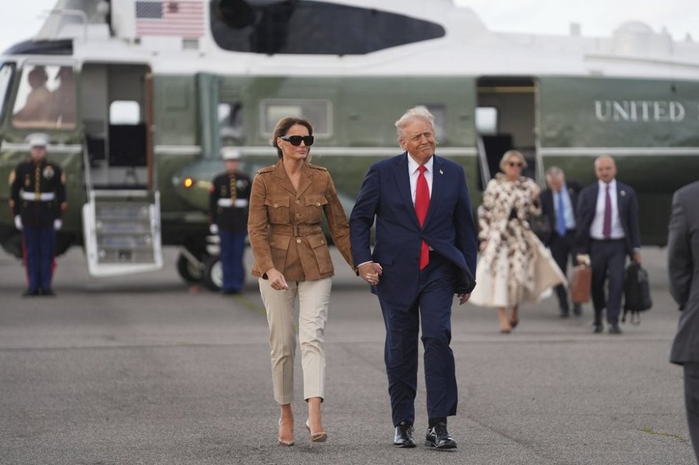 President Donald Trump and first lady Melania Trump walk after arriving on Marine One at Stansted Airport, Thursday, Sept. 18, 2025, in Stansted, England. (AP Photo/Evan Vucci)