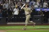 San Diego Padres' Manny Machado gestures as he runs the bases after hitting a grand slam during the fifth inning of a baseball game against the New York Mets Wednesday, Sept. 17, 2025, in New York. (AP Photo/Frank Franklin II)
