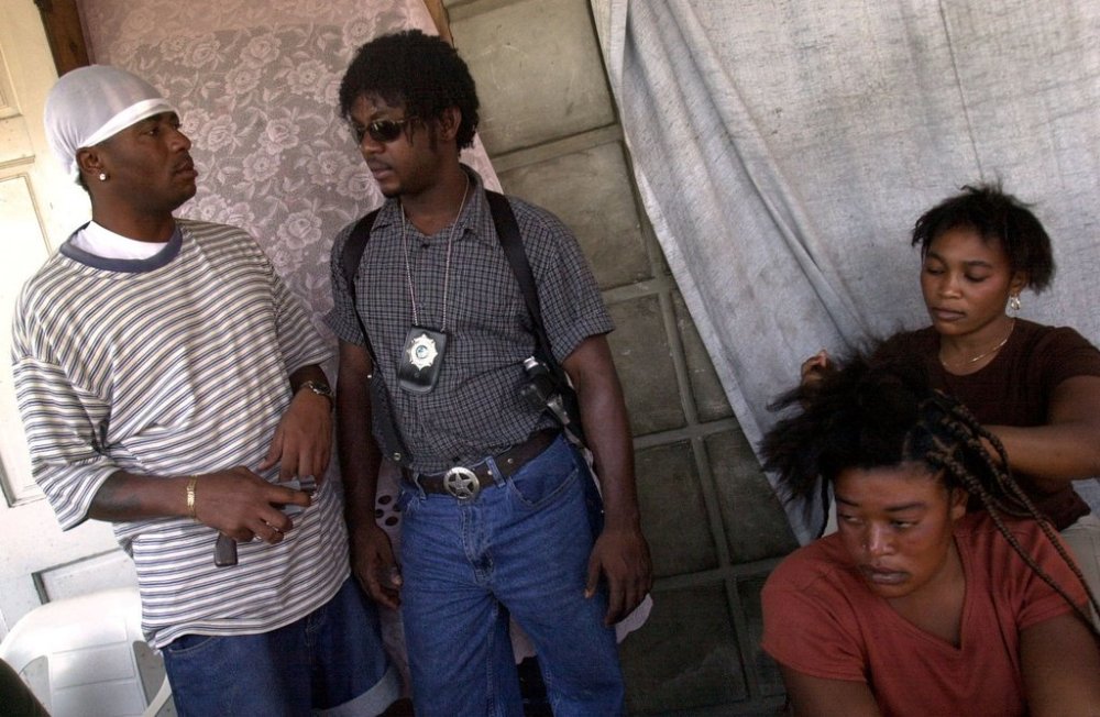 FILE - Wilfort Ferdinand, second left, talks with a member of his security team in Gonaives, March 6, 2004. (AP Photo/Walter Astrada, File)