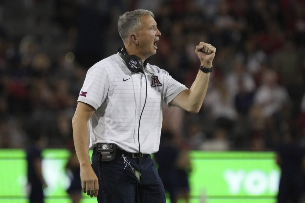 Arizona head coach Brent Brennan reacts after a touchdown against Kansas State in the first half of an NCAA college football game, Friday, Sept 12, 2025, in Tucson, Ariz. (AP Photo/Rick Scuteri)