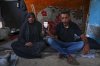 Mohammad and Tahani al-Najjar hold a cellphone showing a picture of their son, Ahmad, at their family's tent in Muwasi, along Gaza's southern coast, Feb. 22, 2025. Nearly two years after Ahmad went missing following Israeli bombardment, the al-Najjars are still searching for him. (AP Photo/Jehad Alshrafi)