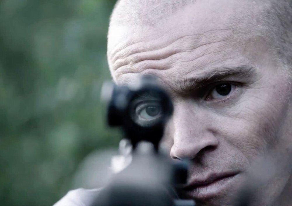 FILE - In this photo provided by Neon, former U.S. Green Beret Jordan Goudreau holds an assault rifle as part of a documentary film on the combat veteran's involvement in a coup attempts against Venezuelan President Nicolas Maduro. (Neon via AP, File)
