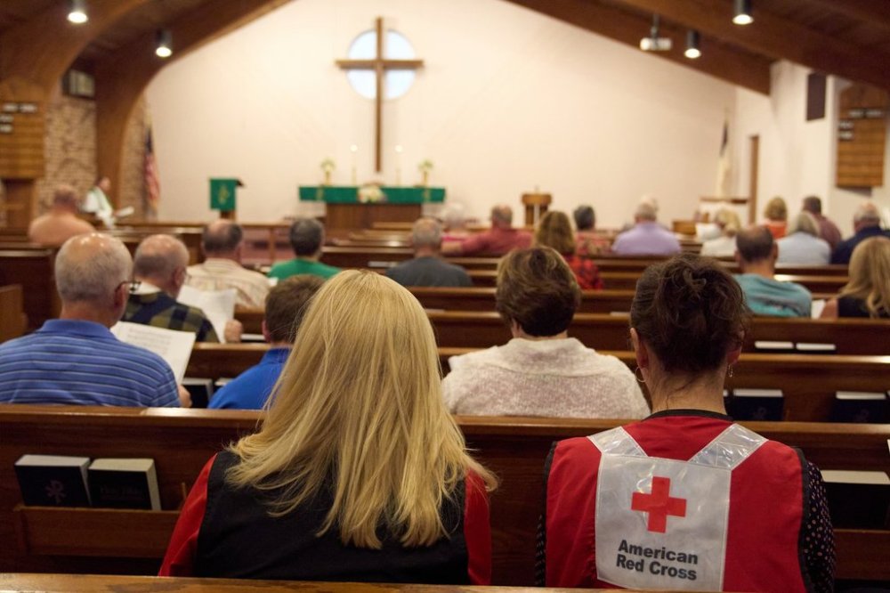 A woman wearing an American Red Cross shirt is seen during a service for the Sunday morning shooting at The Church of Jesus Christ of Latter-day Saints in Grand Blanc Township, Mich., Monday, Sept. 29, 2025. (AP Photo/Ryan Sun)